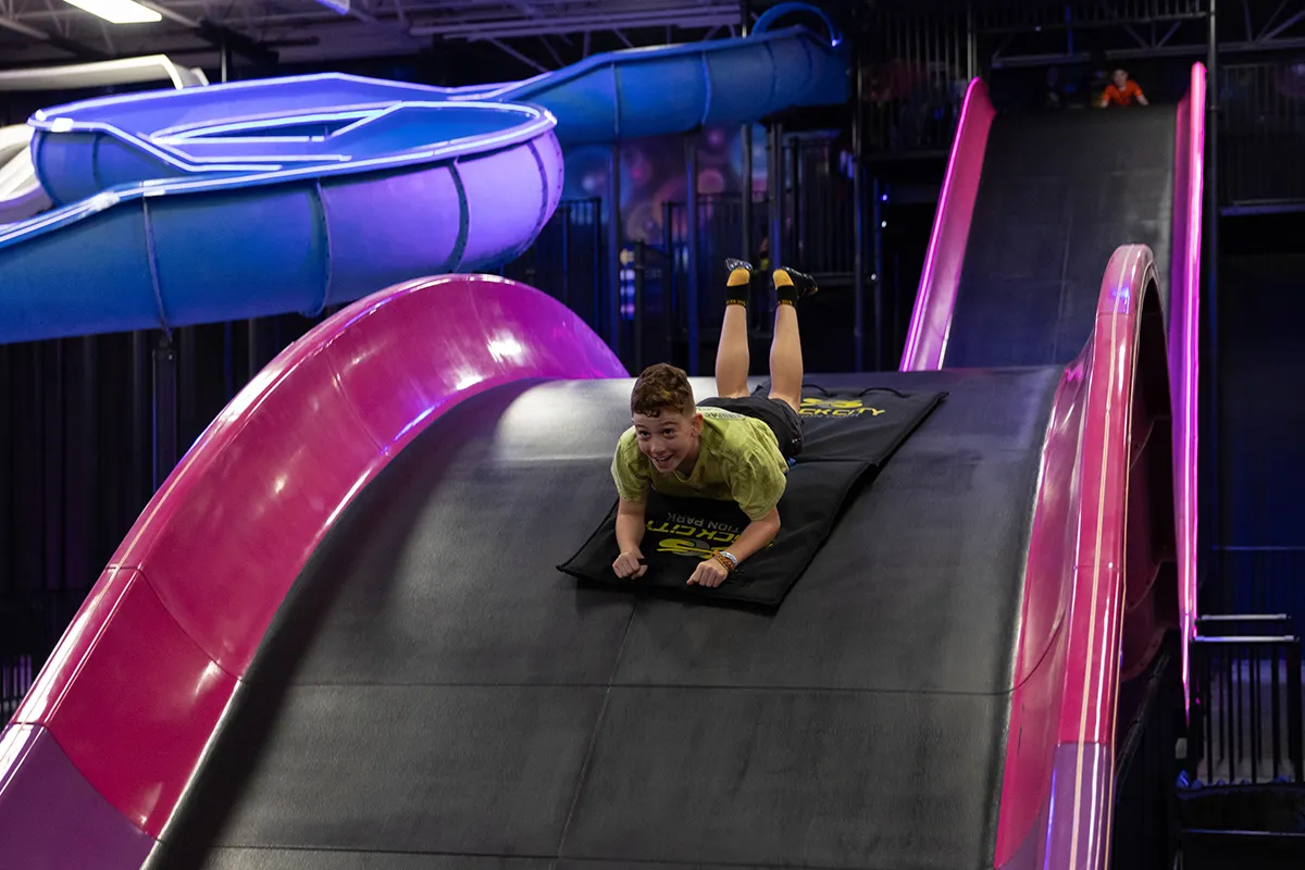 kid going down dragon slide 