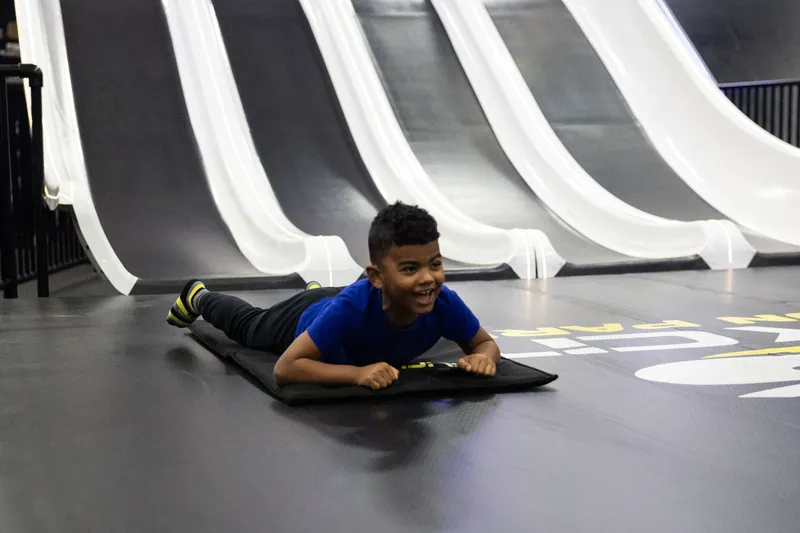 child going down fast lane slide